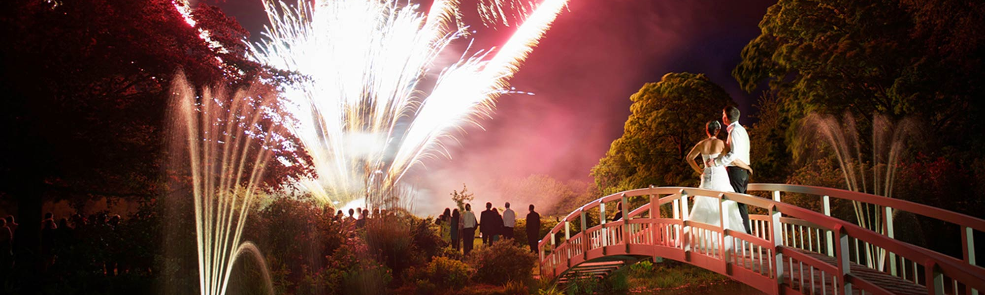 Red wedding fireworks over a lake